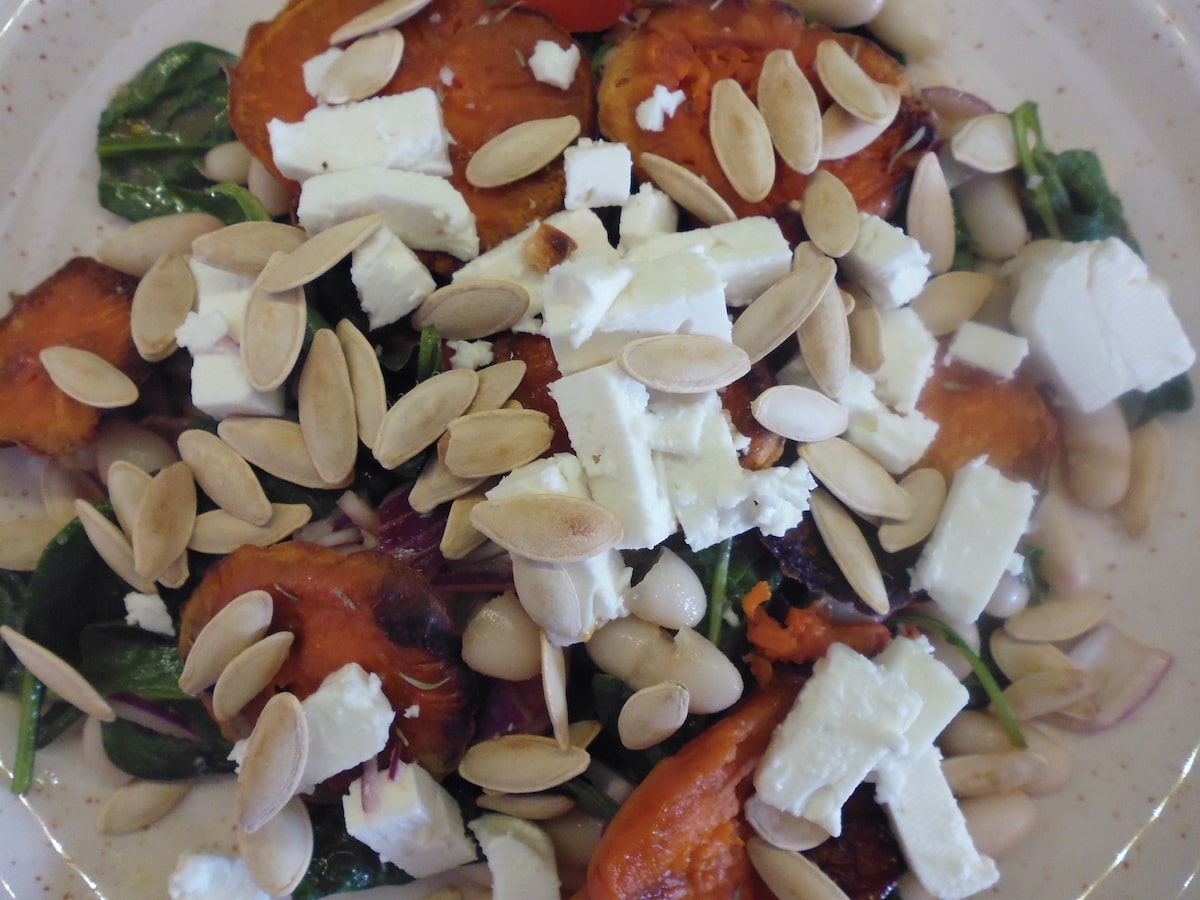 photo of Warm sweet potato salad, with feta cheese, spinach, rocket, beans and tomatoes